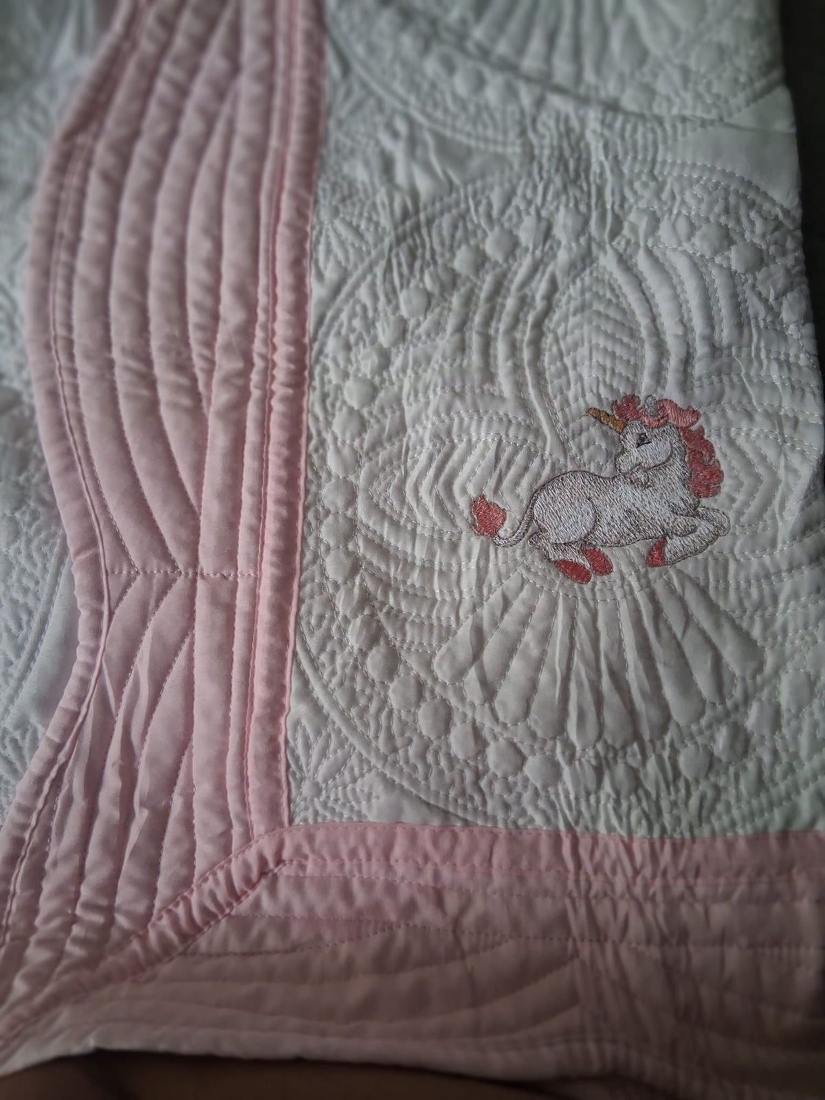 Personalised baby quilt close-up with embroidered design